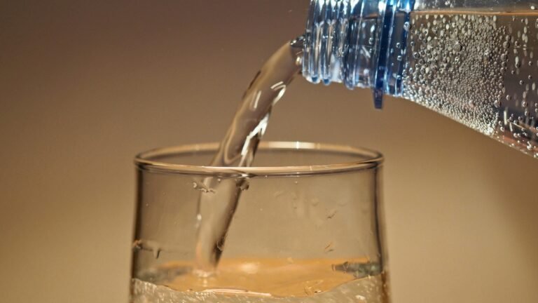 Benefits of Drinking Water illustrated by a person drinking a glass of water to stay hydrated and support overall health